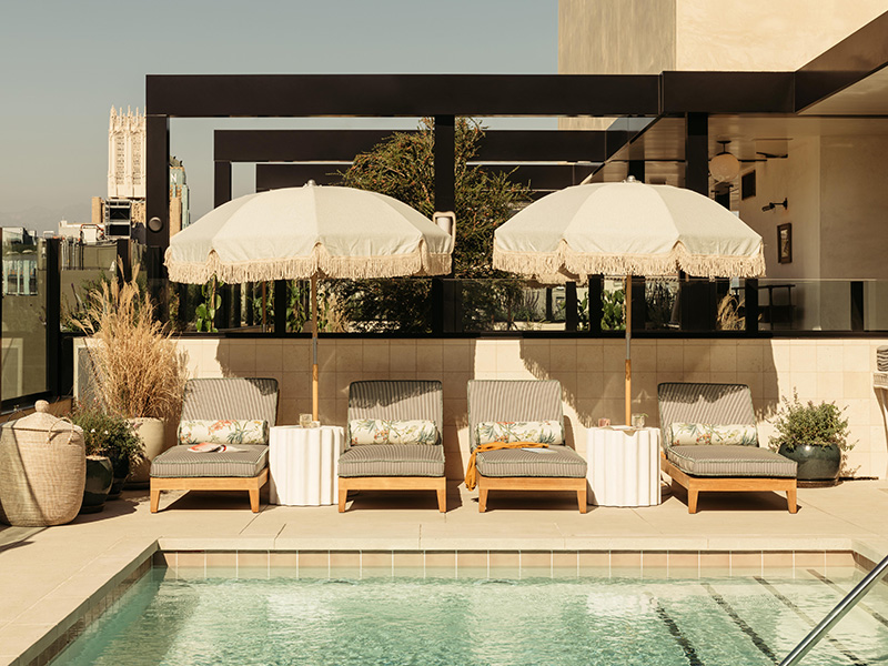 Outdoor swimming pool with sun loungers and umbrellas on a sunny day