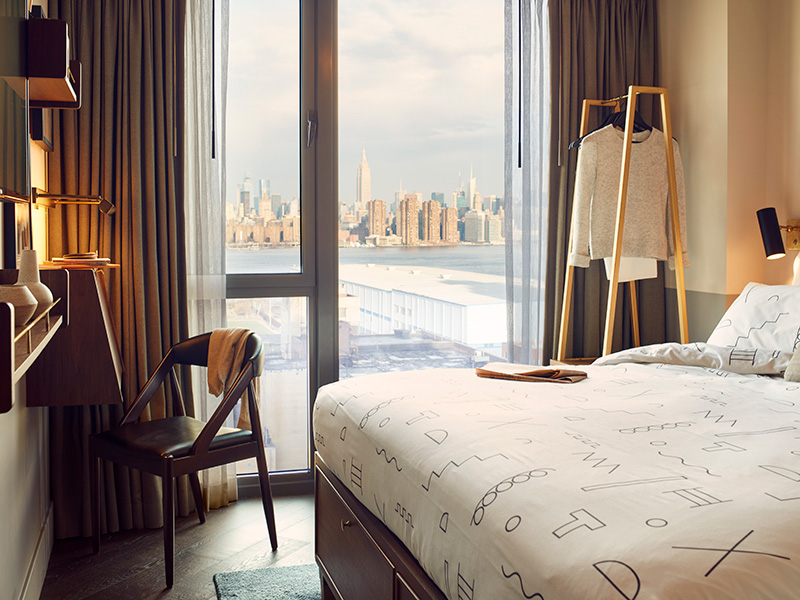 Hotel room with window overlooking Manhattan skyline