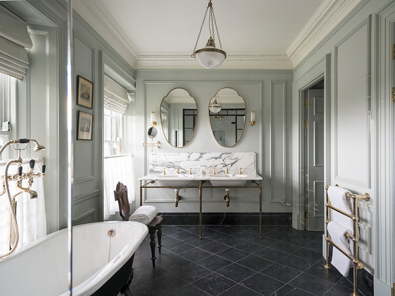 Large bathroom with double sinks and mirrors, with stand alone bath tub
